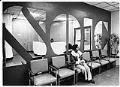 Image of Florence Donley sitting in lobby of new SOIC building, Seattle, January 17, 1975