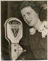 Image of Jane Abernathy posing with new parking meter, July 11, 1941