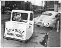 Image of Parking enforcement officer sitting in vehicle, Seattle, Seattle, January 22, 1958