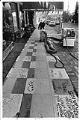 Image of Man removing sidewalk paint outside Duke's restaurant, Seattle, October 14, 1986