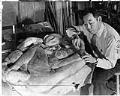 Image of George Tsutakawa with his sculpture 