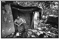 Image of Man sitting in temporary shelter, Seattle, May 1, 1991