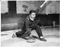 Image of Kearney Kozai with curling stone at the Granite Curling Club, Seattle, January 1960