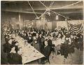 Image of Guests sitting at tables during chili party, Seattle, December 16, 1915