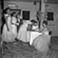 Image of Janice Fair and friends signing guestbook, Seattle, circa 1953