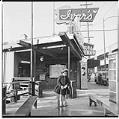 Image of Cheryl Inez Smith standing in front of Ivar's, Seattle, circa 1953