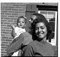 Image of Peoples family standing outside their home, Seattle, circa 1953