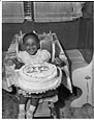 Image of Girl in high chair with birthday cake, Seattle, circa 1955