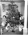 Image of Family around a Christmas tree, Seattle, circa 1950