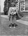 Image of Mrs. Harrison standing outside Garfield High School, Seattle,  May 7, 1950<br />