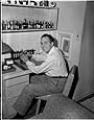 Image of Italian Club president sitting at desk, Seattle, circa 1953
