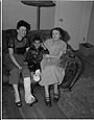 Image of Two women and boy sitting on couch, Seattle, circa 1953