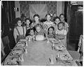 Image of Birthday girl blowing out candles at party, Seattle, circa 1953