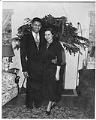 Image of Charlie Taylor and wife standing in living room, Seattle, circa 1953