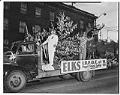 Image of Men waving on Elks parade float, Seattle, April  9, 1950