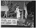 Image of Woman and boy standing on Elks parade float, Seattle, April  9, 1950