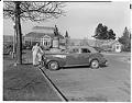 Image of Don Alexander with car at Volunteer Park Conservatory, Seattle, February 9, 1947