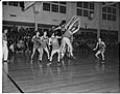 Image of Basketball players jumping for ball, Seattle, December 1948