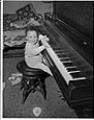 Image of Cheryl Inez Smith playing the piano, Seattle, circa 1955