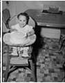 Image of Cheryl Inez Smith sitting in kitchen, Seattle, circa 1955