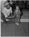 Image of Slick Adams sitting with a small boy, Seattle circa 1953