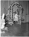 Image of Model under trellis at a fashion show, Seattle, circa 1953