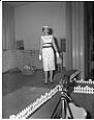 Image of Woman modeling dress on stage, Seattle, circa 1953