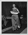 Image of Woman modeling evening dress at a fashion show, circa 1955