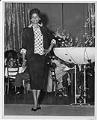 Image of Woman modeling outfit at fashion show, circa 1955