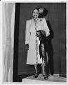Image of Woman modeling outerwear at fashion show, circa 1955
