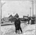 Image of Boy and dog in snow on 3rd Avenue, Seattle, 1897