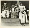 Image of Indigenous women and infant on porch, circa 1900