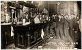 Image of Bartenders and patrons holding beer glasses at Hotel Globe bar, Seattle, circa 1910