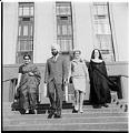 Image of Four people leaving courthouse after naturalization ceremony, March 1, 1965