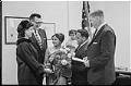 Image of Suman Gupta and family in office after she received permanent residency,  March, 1966