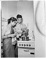 Image of Padmini Vasishth and her husband in their kitchen, January 11, 1955