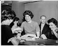 Image of Suzie Ordogh signing naturalization papers inside courthouse, Seattle, April 23, 1962