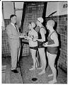 Image of Nancy Ramey receiving trophy at WAC swim meet, Seattle, March 1957