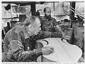 Image of Hammond Ashley and Dave Wilson working on a bass in their workshop, Seattle, July 18, 1989