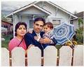 Image of Harish Bharti and family in front of their home, May 24, 1990