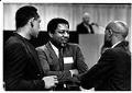 Image of John Johnson, Fred Brown, and Slick Watts talking together at Kingdome event, Seattle March 27, 1991