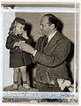 Image of Jesse Epstein receiving cup of punch from child after Yesler Terrace dedication, Seattle, June 16, 1942