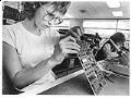 Image of Leigh Barnes working on inspection line at Fluke Manufacturing, Everett, December 26, 1985
