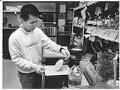 Image of Noel Balantac working in lab at Immunex, Seattle, December 12, 1989