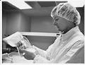 Image of Product technician inspecting package at IMRE Corporation lab, Seattle, March 1, 1993