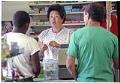 Image of Grace Chung with customers at Jeff Mart grocery store, Seattle, September 30, 1992