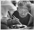 Image of Hua Ok Pak eating lunch at Lakewood Community Center, January 1990