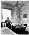 Image of Bob Santos visiting apartment in need of renovation, Seattle, December 15, 1980