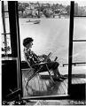 Image of Marjorie Lothrop reading on houseboat docked on Lake Union, Seattle, July 16, 1952