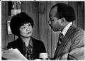 Image of Dolores Sibonga and Bill Hilliard talking at Washington State Human Rights Commission offices, Seattle, December 19, 1978